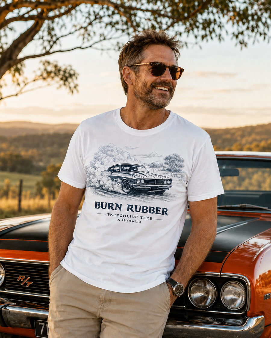 Man wearing a Sketchline Tees classic-car design beside an orange Australian muscle car